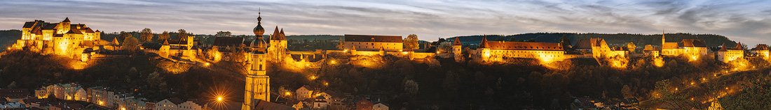 Panoramic view of Burg Burghausen illuminated at night.