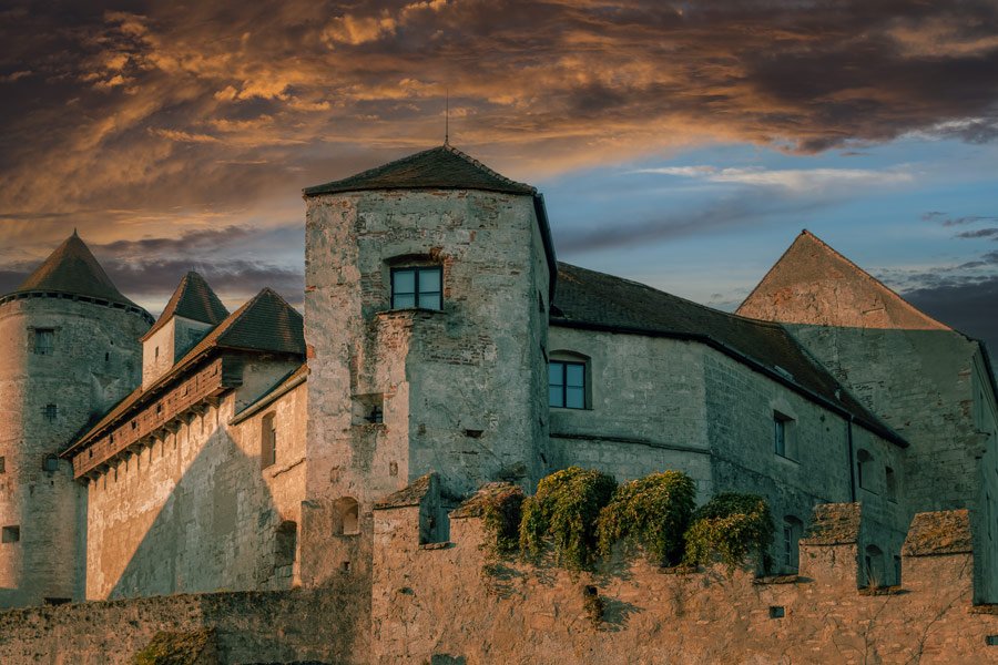 Historic stone walls and towers of Burghausen Castle at sunset in Bavaria, Germany